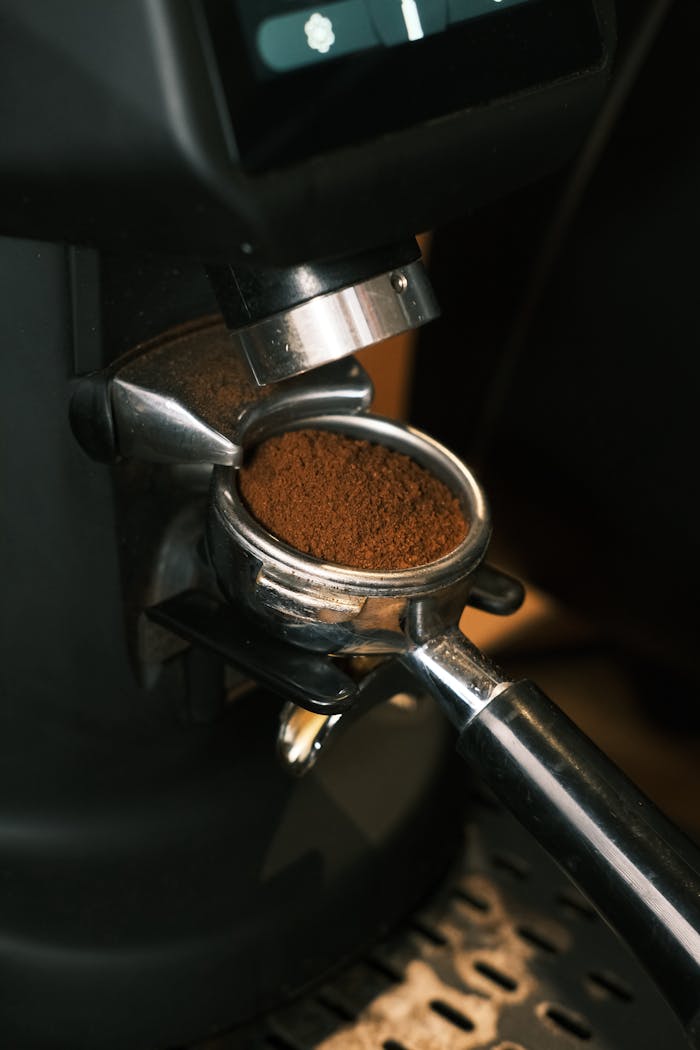 services-02 Detailed shot of ground coffee in a portafilter at a modern café setting.